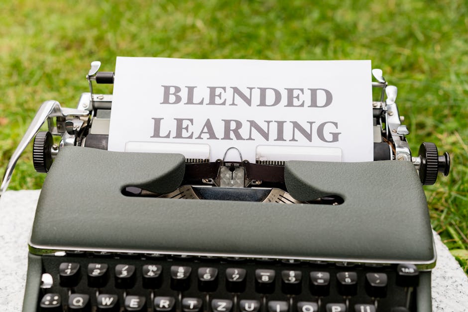 Vintage typewriter with a paper showing 'Blended Learning' text on grass.